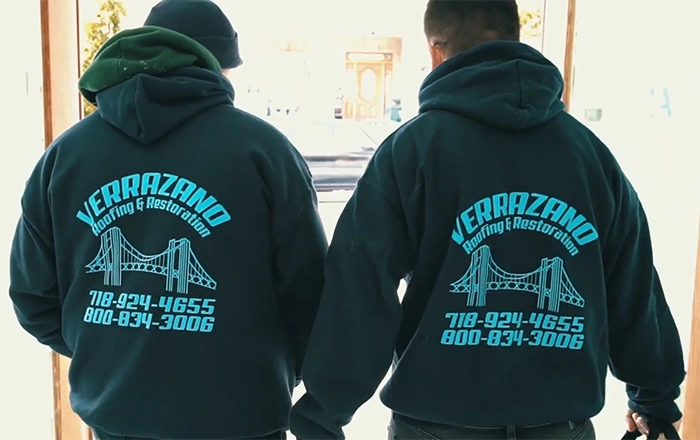 Two Verrazano team members wearing jackets with the company’s bridge logo
