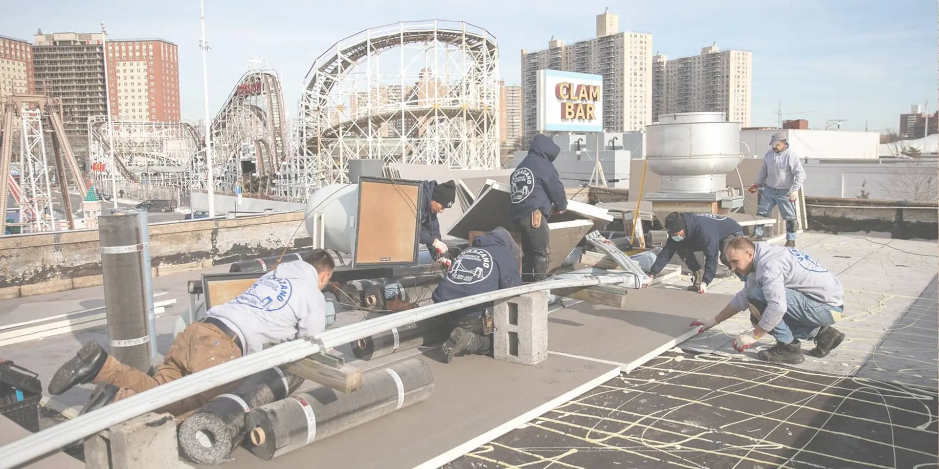 Verrazano’s crew at work, with Coney Island’s roller coaster in the background.